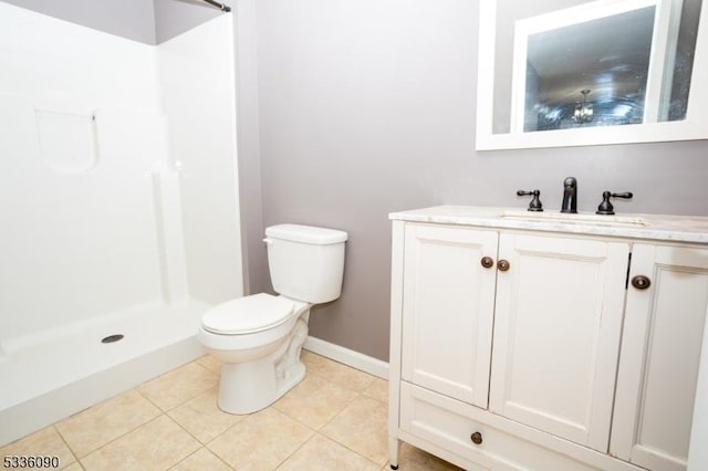 bathroom with tile patterned flooring, vanity, walk in shower, and toilet