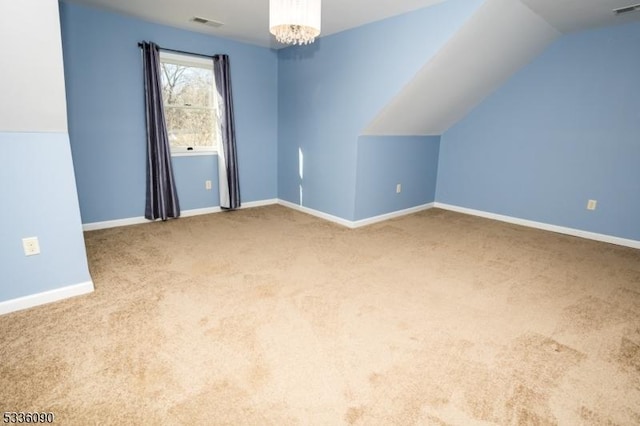 bonus room with lofted ceiling, an inviting chandelier, and carpet