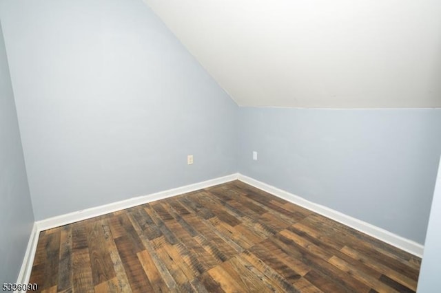 bonus room featuring dark hardwood / wood-style floors and vaulted ceiling