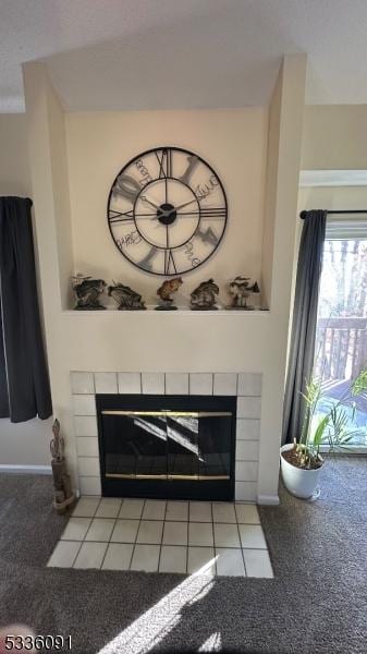 details featuring a tile fireplace and carpet floors