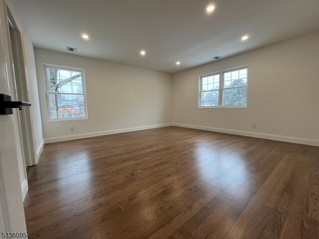 empty room featuring dark wood-type flooring