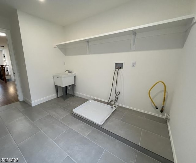 laundry area with washer hookup, sink, and tile patterned flooring