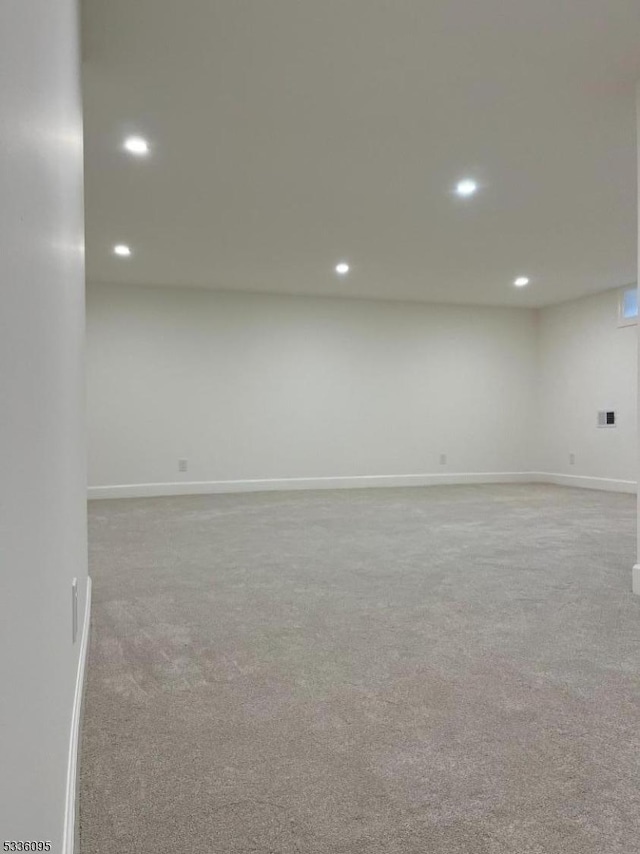 basement featuring light colored carpet