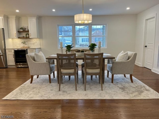 dining space featuring wine cooler and dark hardwood / wood-style flooring