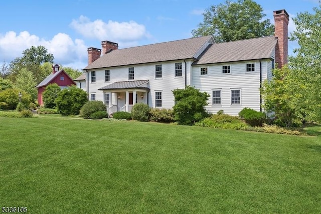 colonial-style house with a front yard and covered porch