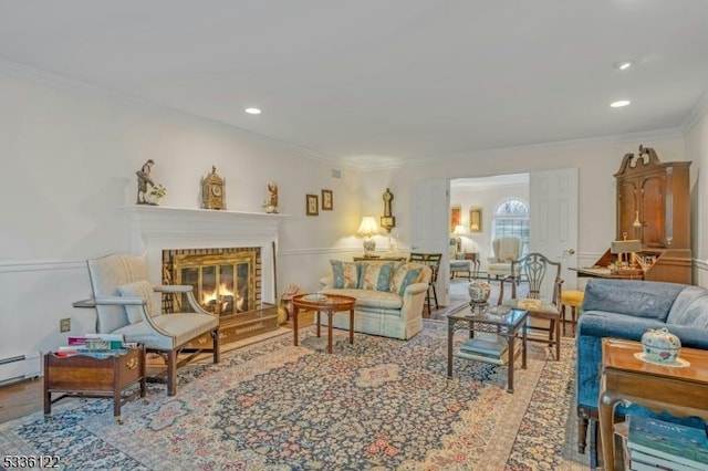 living room featuring a baseboard heating unit, wood-type flooring, and ornamental molding