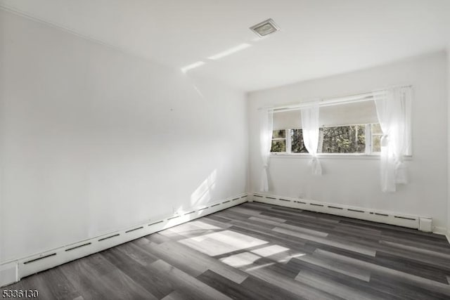 empty room with a baseboard radiator and dark wood-type flooring