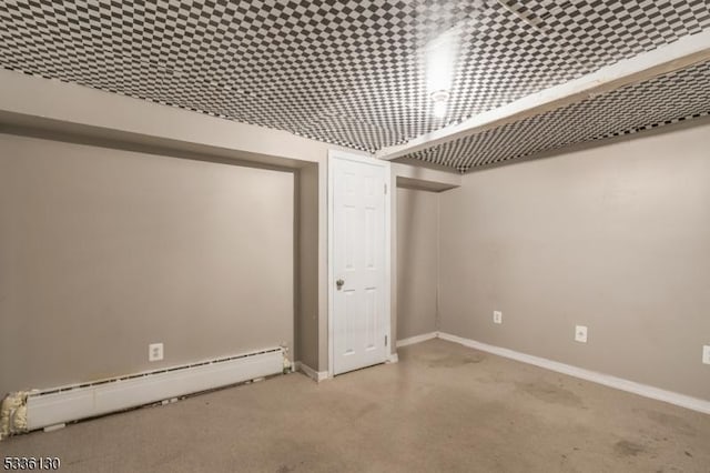 basement featuring a baseboard heating unit