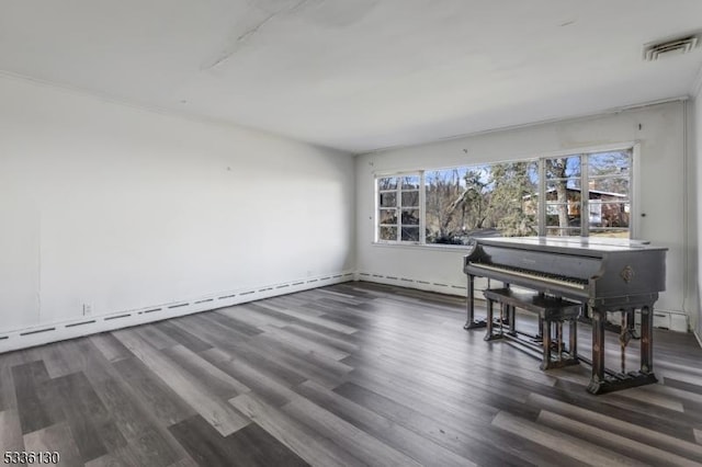 unfurnished dining area featuring a healthy amount of sunlight, dark hardwood / wood-style flooring, and baseboard heating