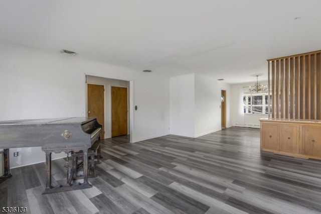 interior space featuring dark hardwood / wood-style floors and an inviting chandelier