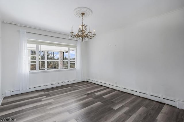 empty room with a baseboard heating unit, dark wood-type flooring, and an inviting chandelier