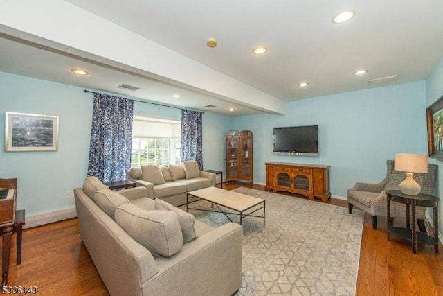 living room featuring hardwood / wood-style flooring and beam ceiling