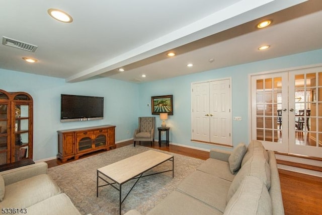 living room with french doors, beam ceiling, and hardwood / wood-style flooring