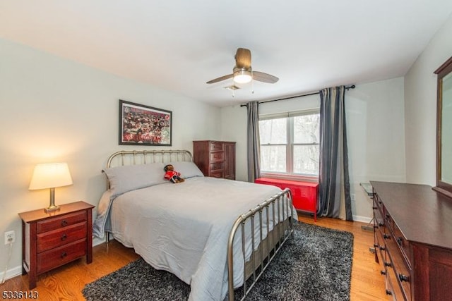 bedroom with ceiling fan and light wood-type flooring