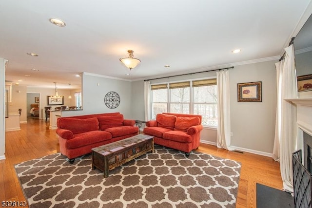 living room with crown molding and hardwood / wood-style flooring