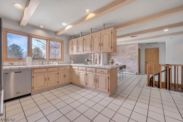 kitchen featuring beamed ceiling, decorative backsplash, stainless steel dishwasher, tile counters, and kitchen peninsula