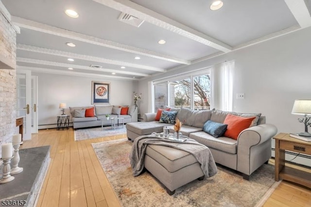 living room featuring beamed ceiling, baseboard heating, and light hardwood / wood-style flooring