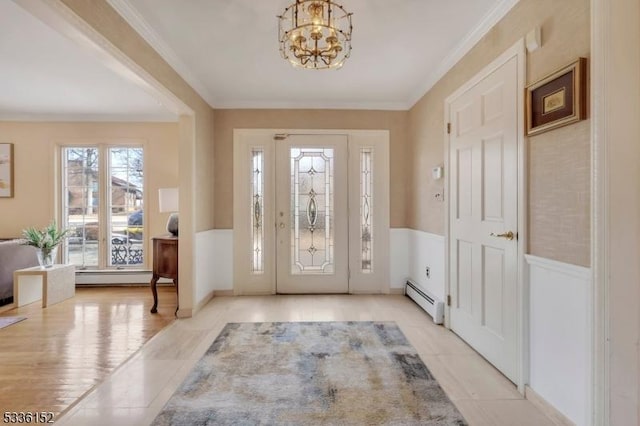 tiled foyer with an inviting chandelier, a baseboard radiator, and ornamental molding