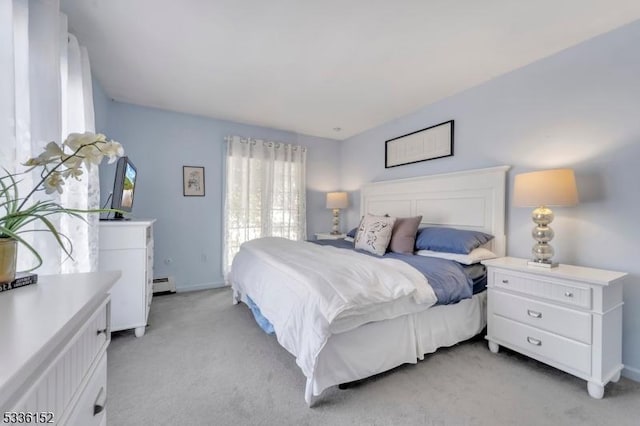 bedroom featuring baseboard heating and light carpet