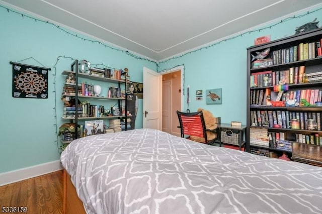 bedroom with wood finished floors and baseboards