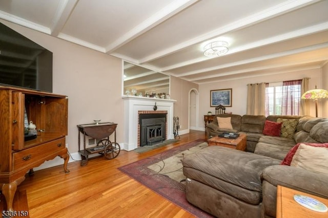 living area with beamed ceiling and wood finished floors