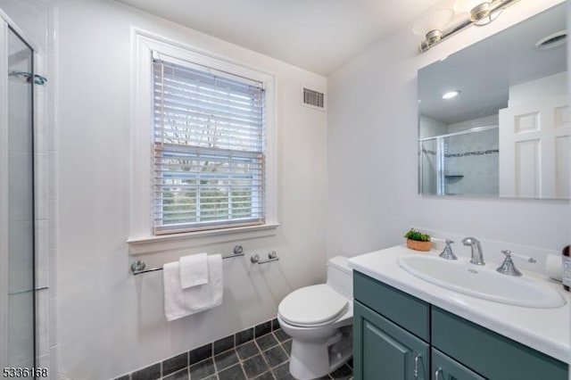 bathroom featuring vanity, toilet, tile patterned flooring, and a shower with door