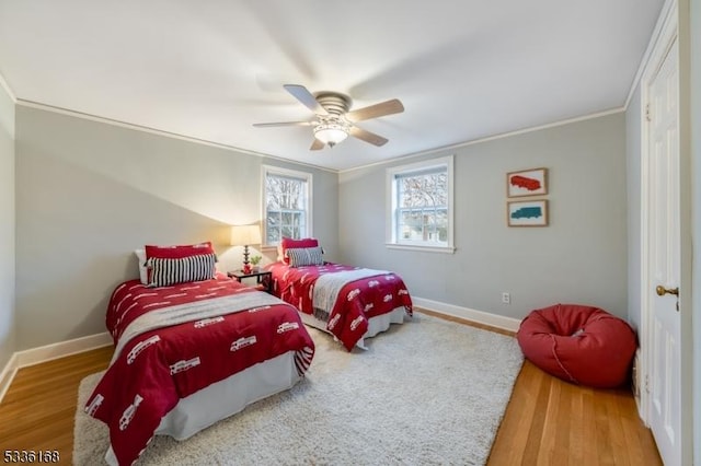 bedroom with hardwood / wood-style flooring, ceiling fan, and crown molding