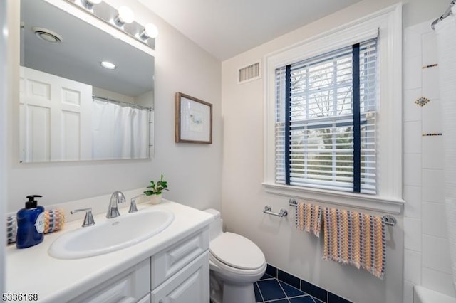 bathroom with vanity, tile patterned flooring, and toilet