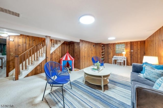 living room featuring carpet floors and wood walls