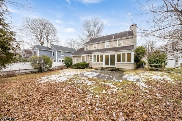 back of property with a patio