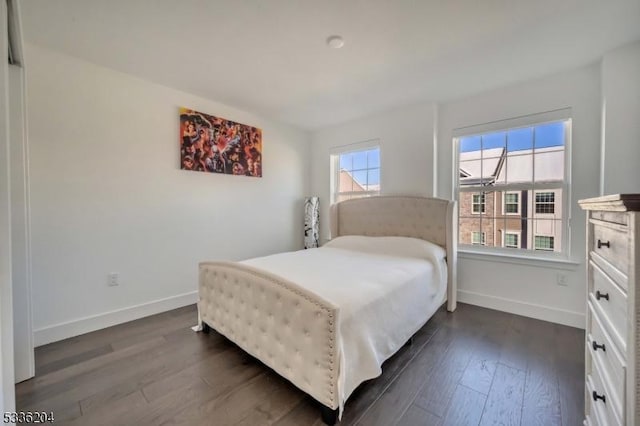 bedroom with dark hardwood / wood-style floors