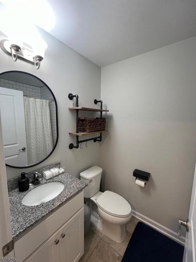 bathroom featuring vanity, tile patterned flooring, a shower with curtain, and toilet