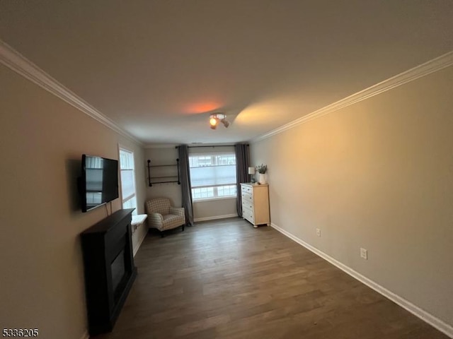 unfurnished living room with dark wood-type flooring and ornamental molding