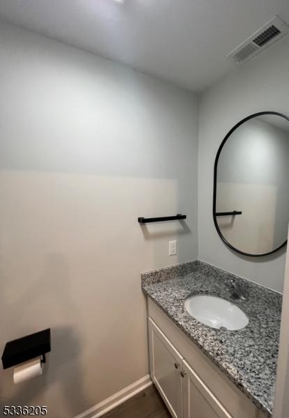 bathroom with vanity and hardwood / wood-style flooring