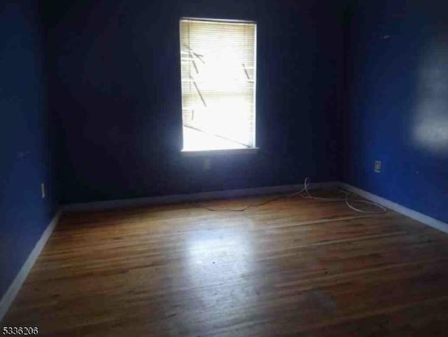 spare room featuring dark hardwood / wood-style flooring