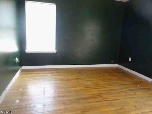 unfurnished room featuring wood-type flooring