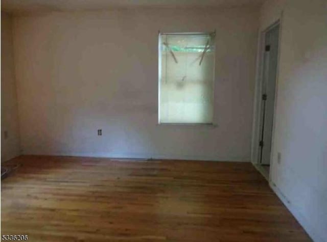 unfurnished room featuring hardwood / wood-style flooring