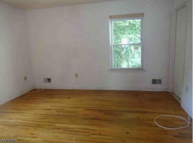 unfurnished room with light hardwood / wood-style flooring