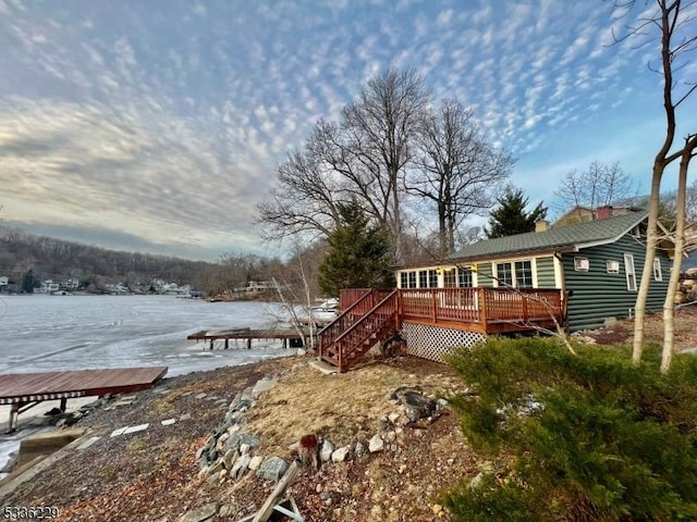 exterior space with a deck with water view