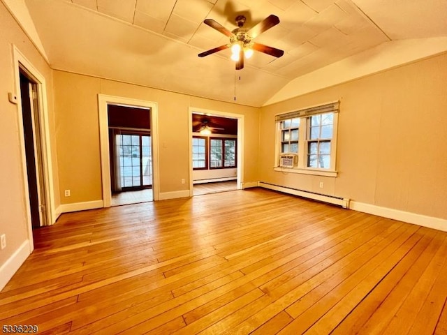 spare room with vaulted ceiling, light hardwood / wood-style floors, ceiling fan, and baseboard heating