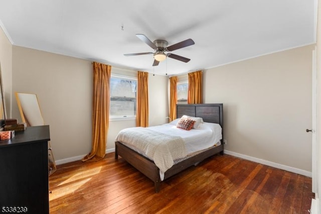 bedroom with hardwood / wood-style flooring, a ceiling fan, and baseboards