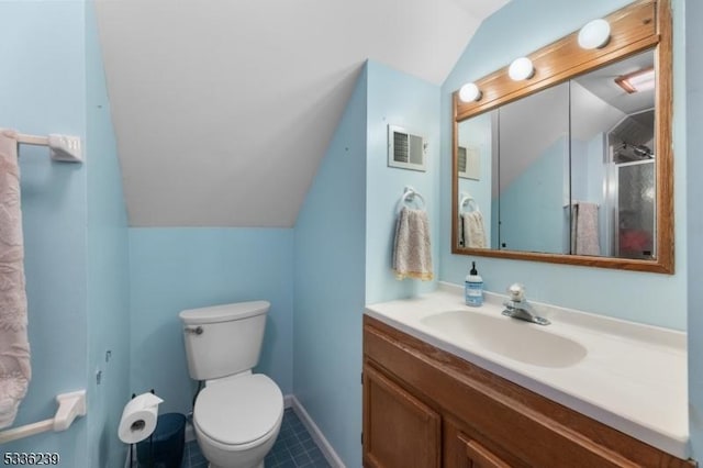 bathroom with visible vents, toilet, baseboards, vanity, and vaulted ceiling