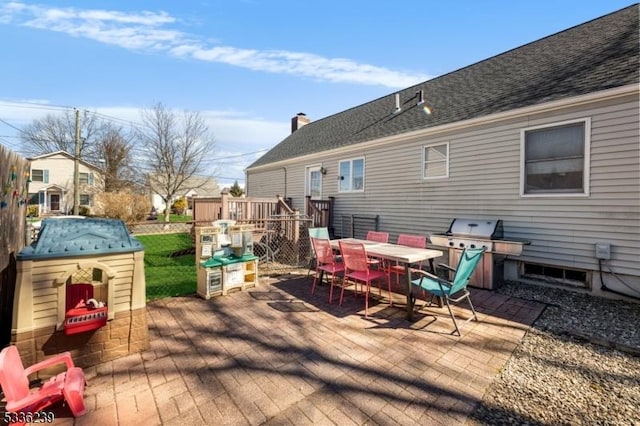 deck featuring grilling area and outdoor dining area