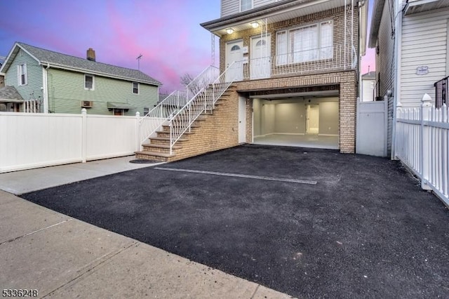 parking at dusk featuring a garage