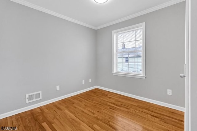 unfurnished room featuring crown molding and wood-type flooring