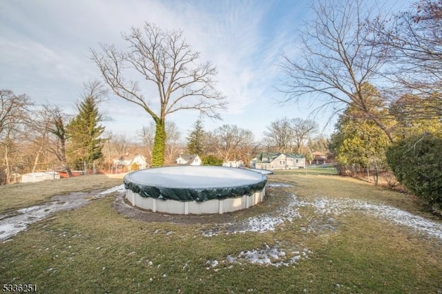 view of yard with a covered pool