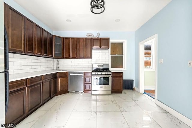 153-157 Stuyvesant Ave, Newark City, NJ 07106 - kitchen featuring appliances with stainless steel finishes, radiator heating unit, sink, decorative backsplash, and dark brown cabinetry