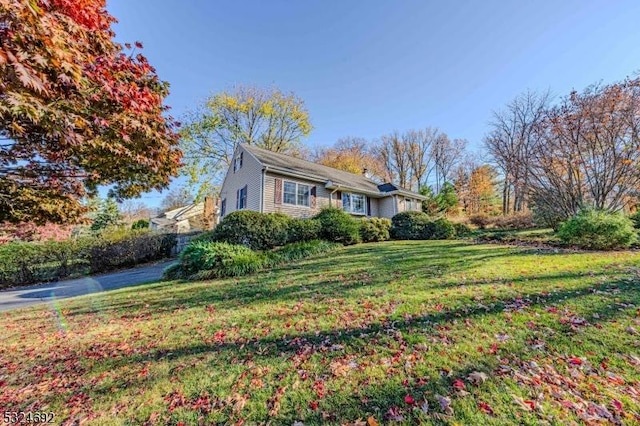 view of side of home with a lawn