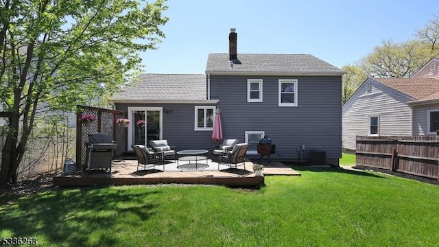 back of house featuring fence, a patio, a chimney, an outdoor hangout area, and a lawn