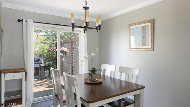dining room featuring ornamental molding and a chandelier
